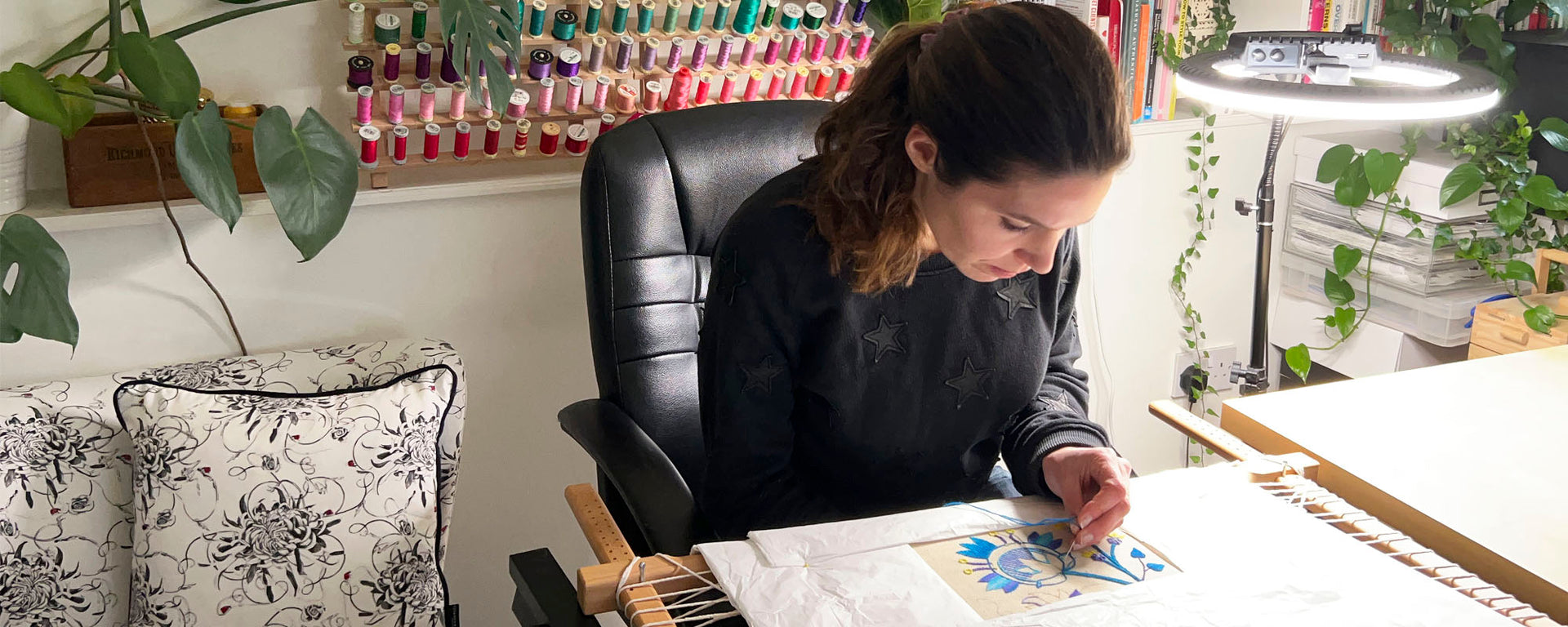 Susannah hand embroidering in her studio