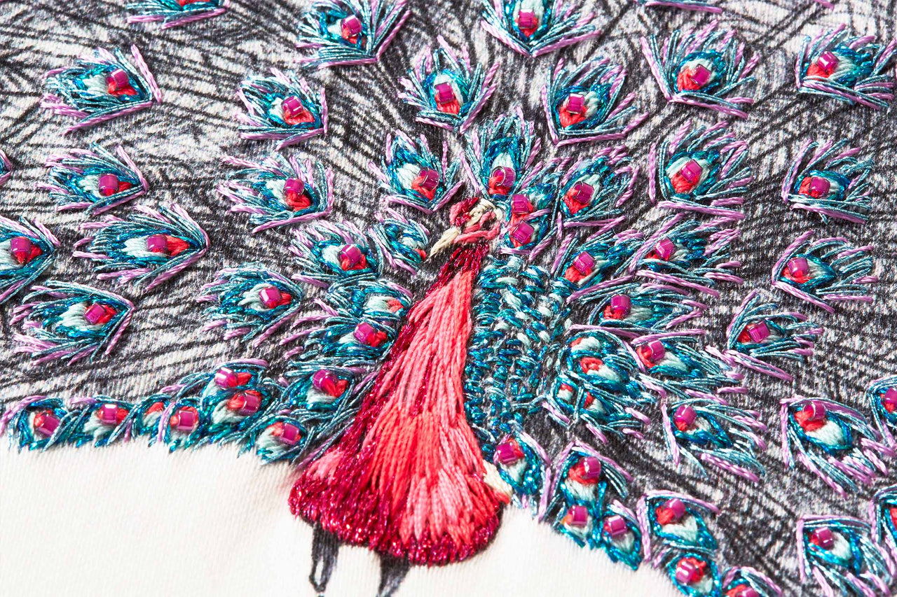Pink peacock hand embroidery close up detail