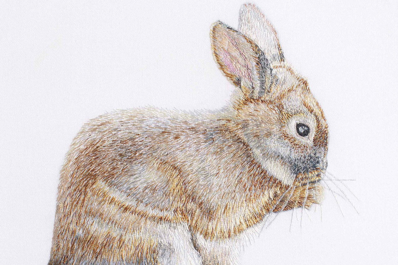 Bunny rabbit hand embroidered artwork.