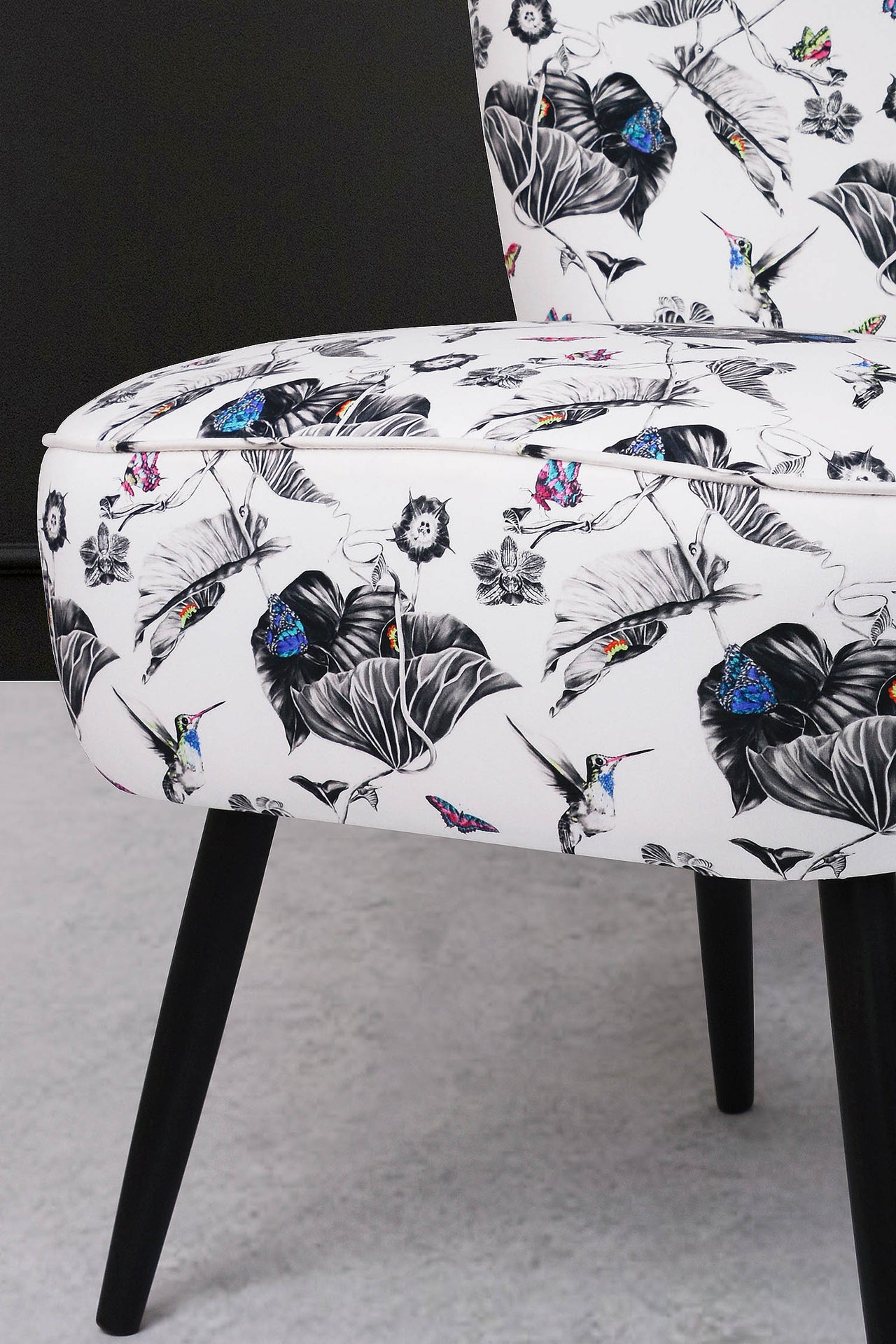 Cocktail chair upholstered with multi hummingbirds fabric.