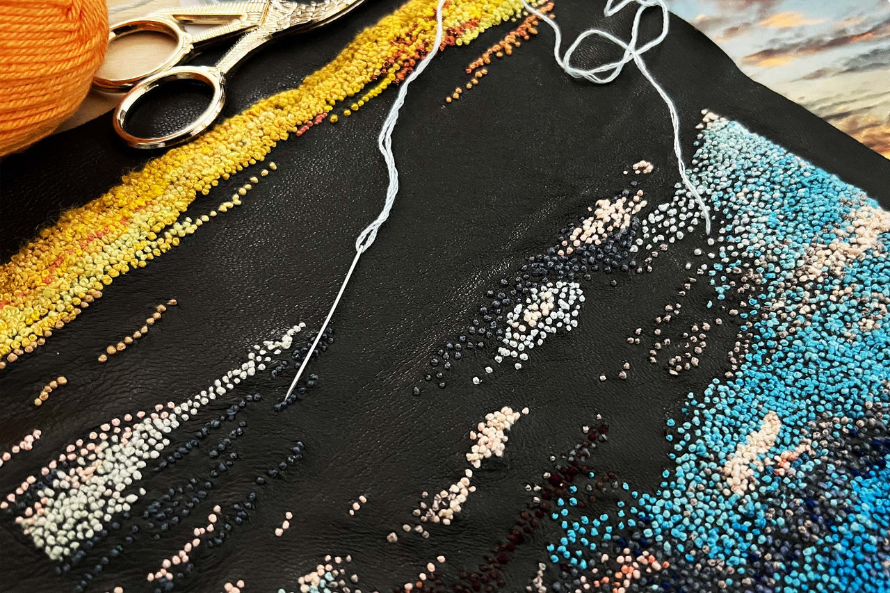Hand embroidering into leather at Decorex Making Space 2022.