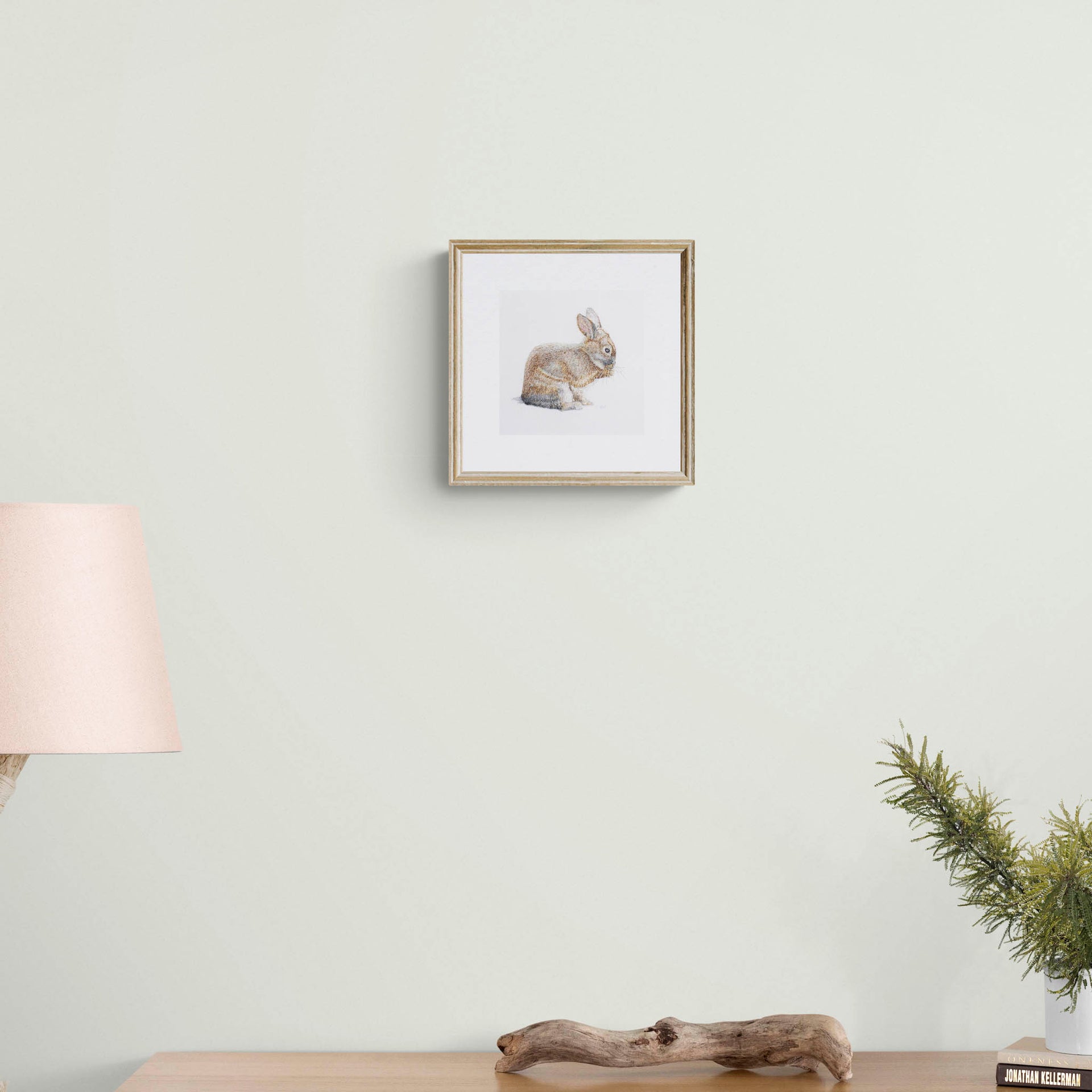 Hand embroidered bunny limited edition print in frame on the wall