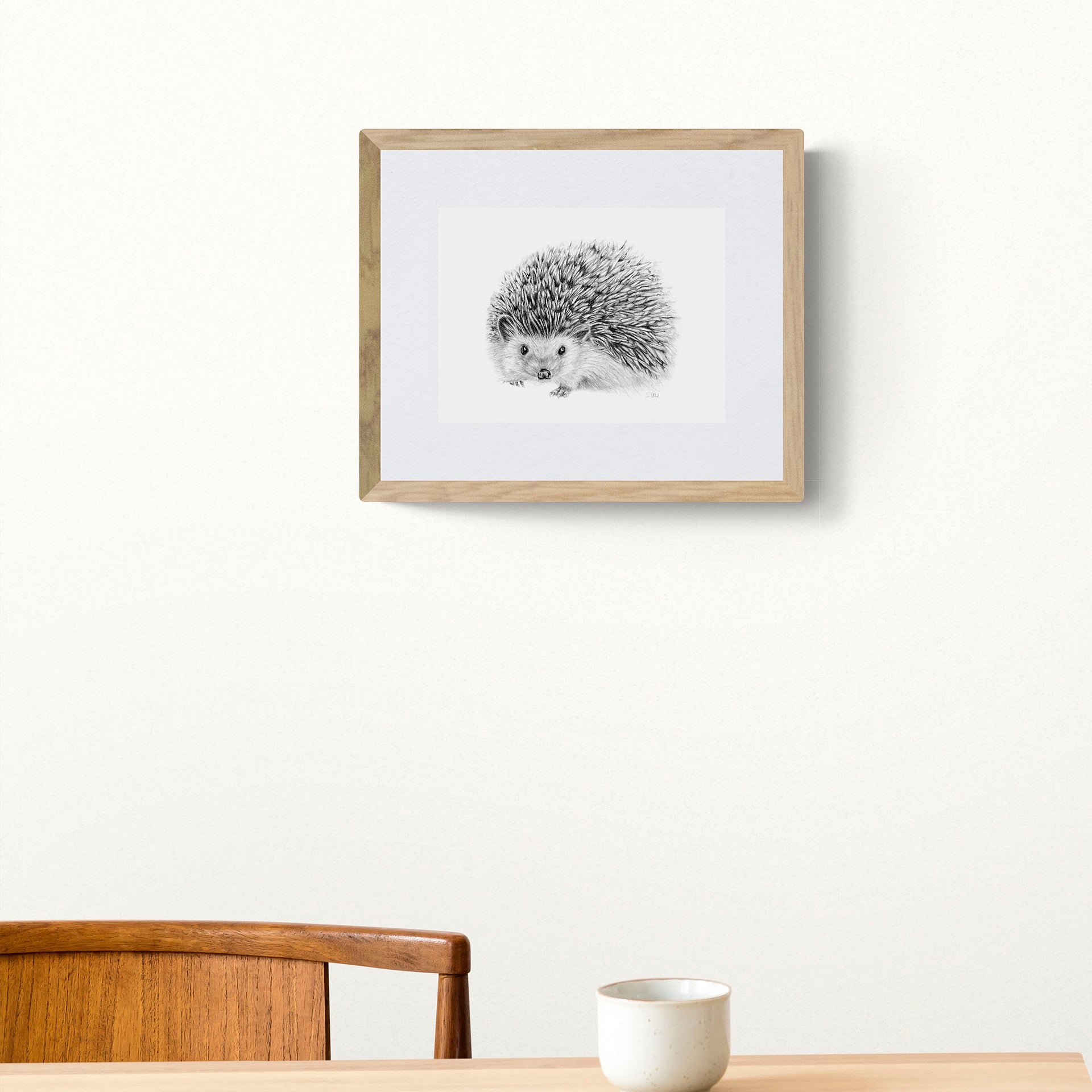 Hedgehog pencil drawing print in frame on the wall