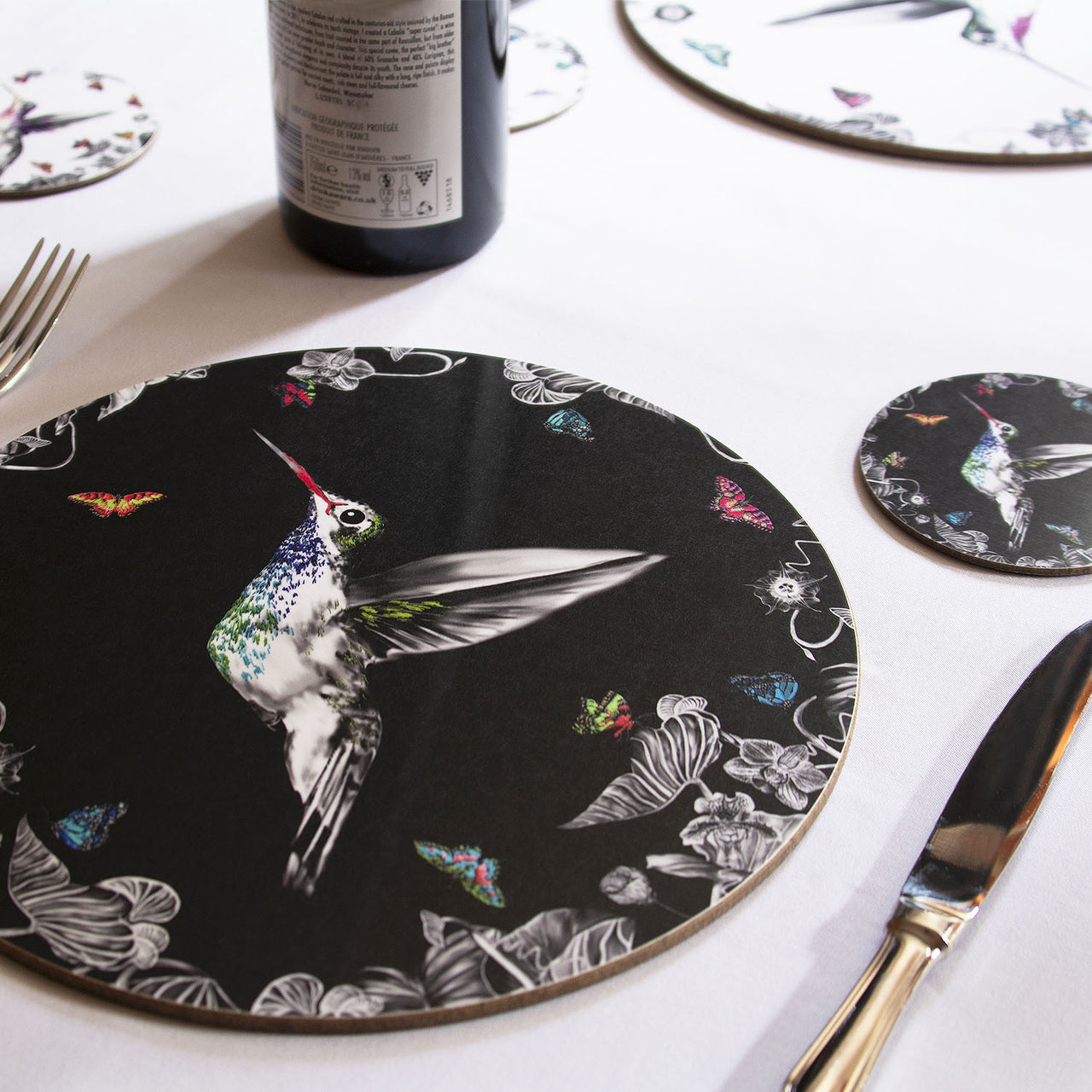 Black hummingbird placemat on table