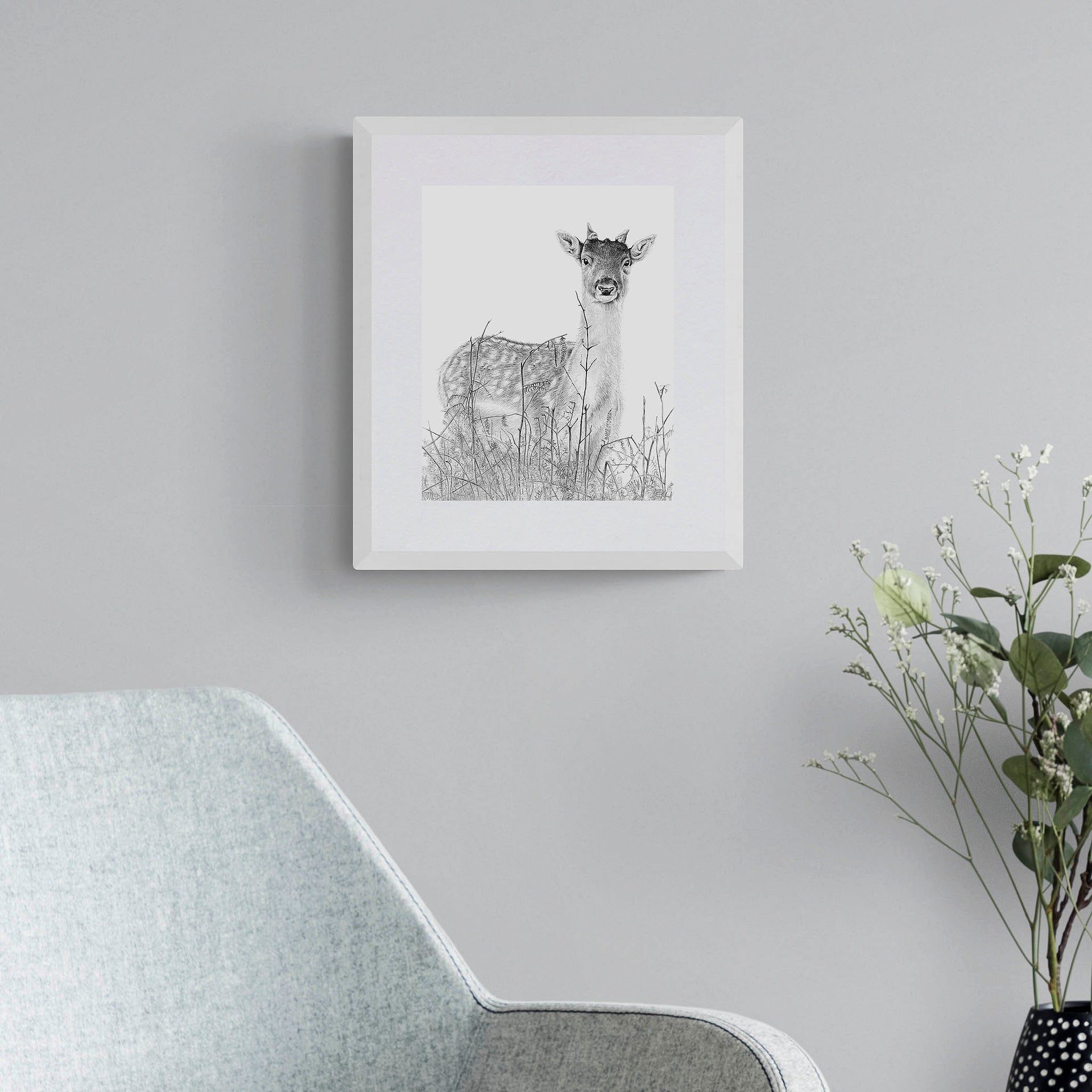 Deer pencil drawing art print in white frame on the wall