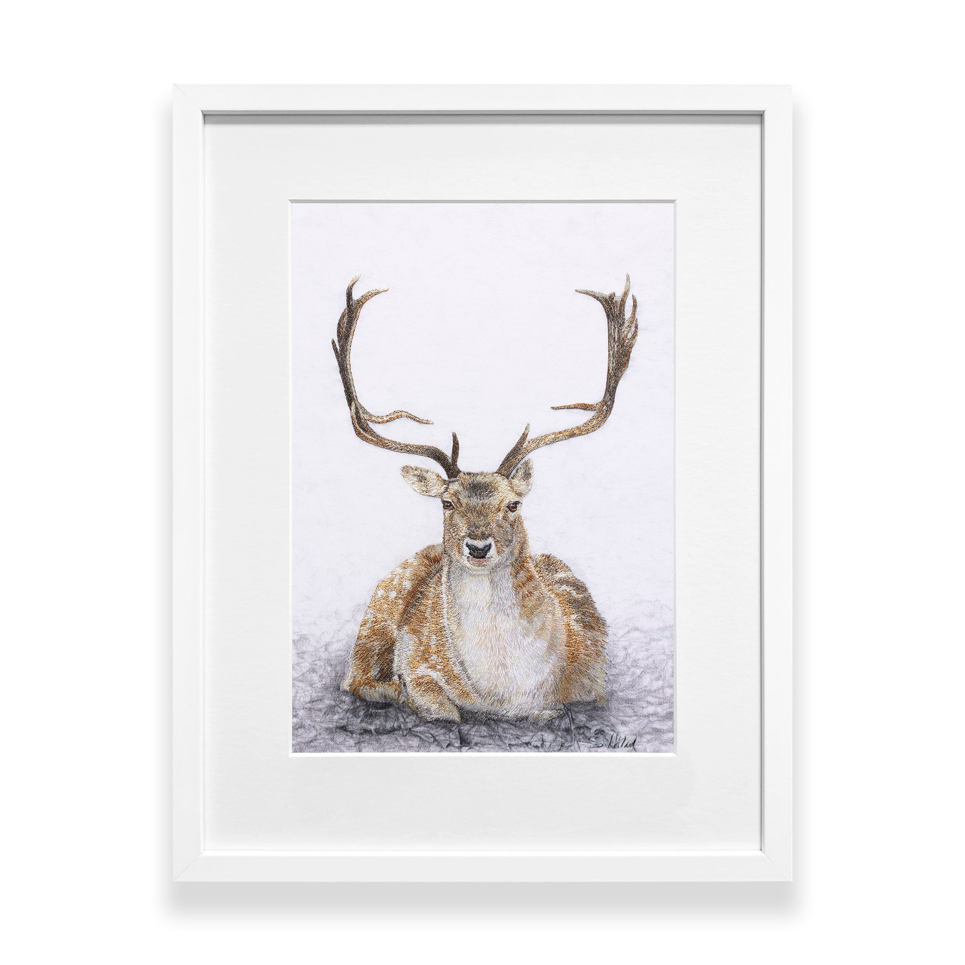Hand embroidered sitting Deer artwork in a white frame