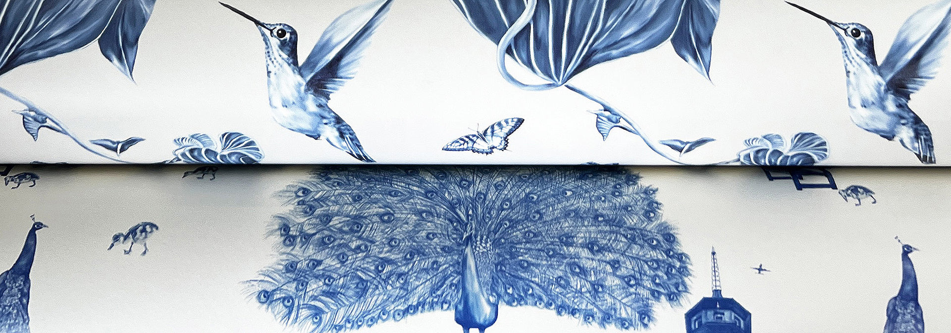 Hummingbirds and Kew Peacock wallpaper samples in Delft blue.
