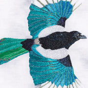 Hand embroidered flying Magpie artwork close up