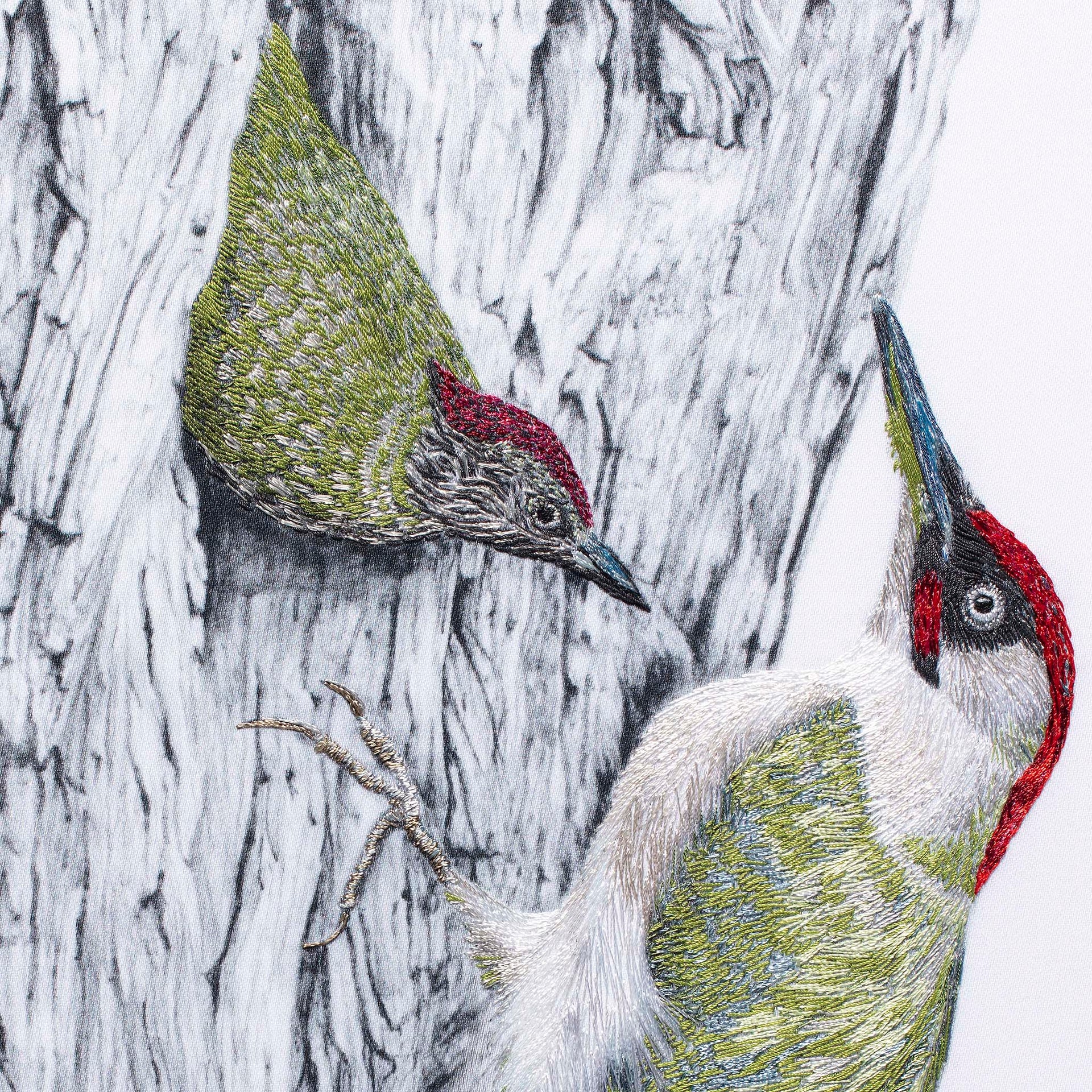 Woodpeckers hand embroidered wall art close up.