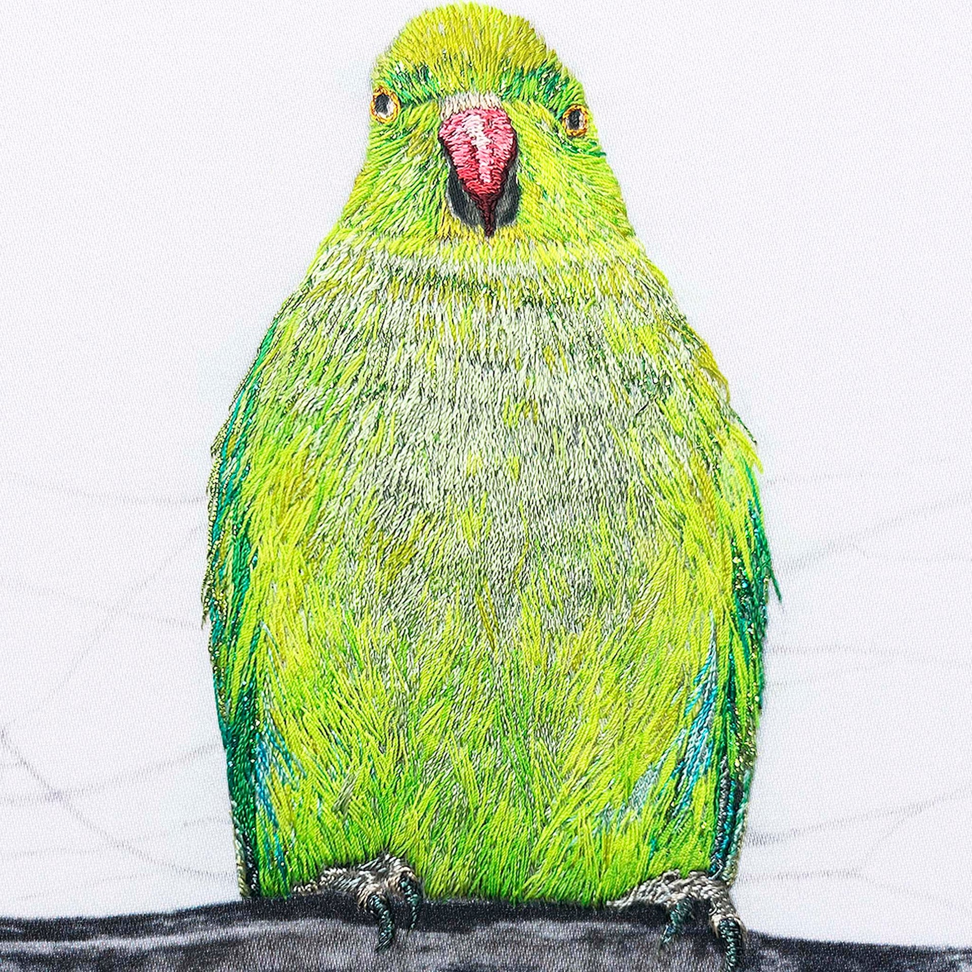 Parakeet hand embroidered wall art close up.