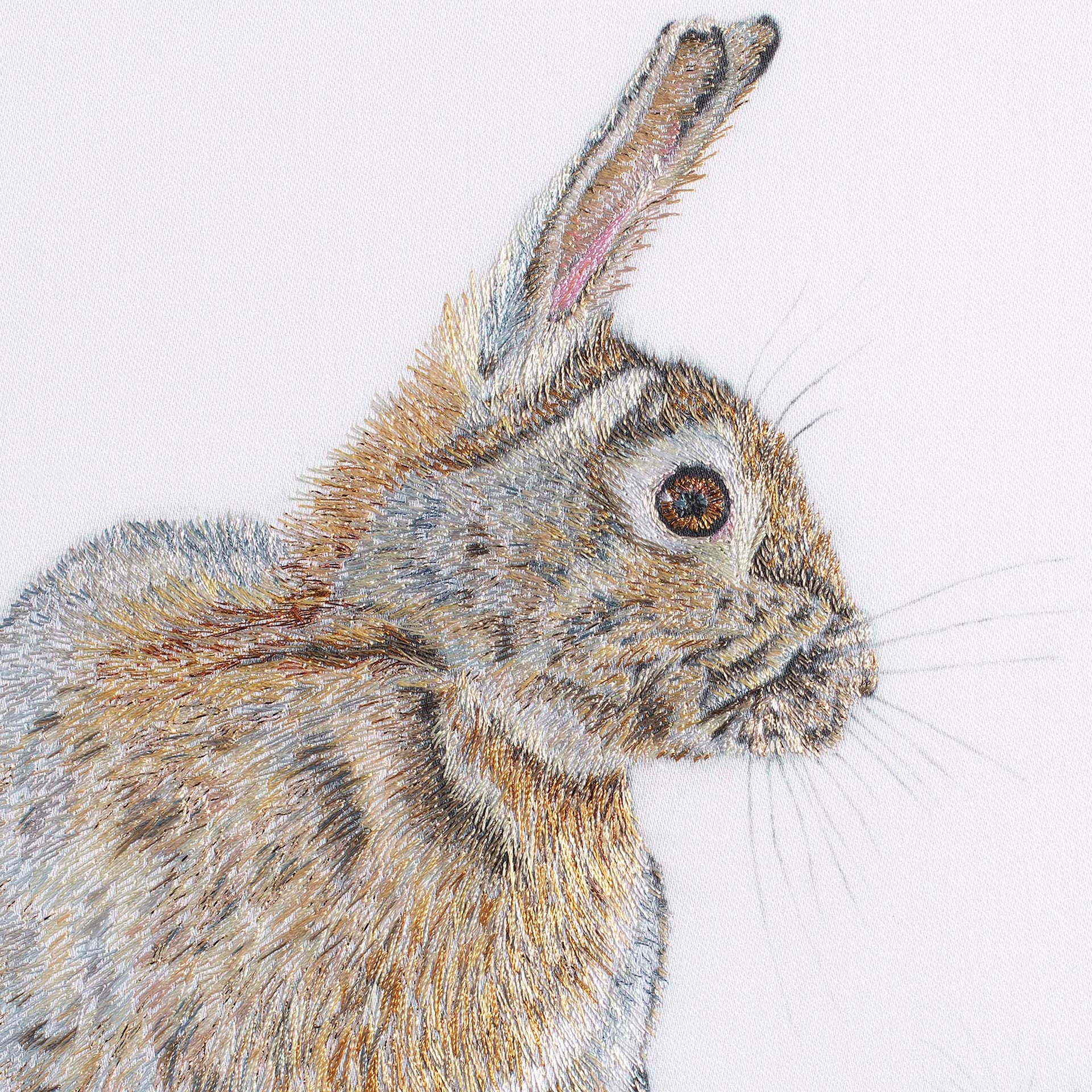 Rabbit and mouse hand embroidered wall art close up.