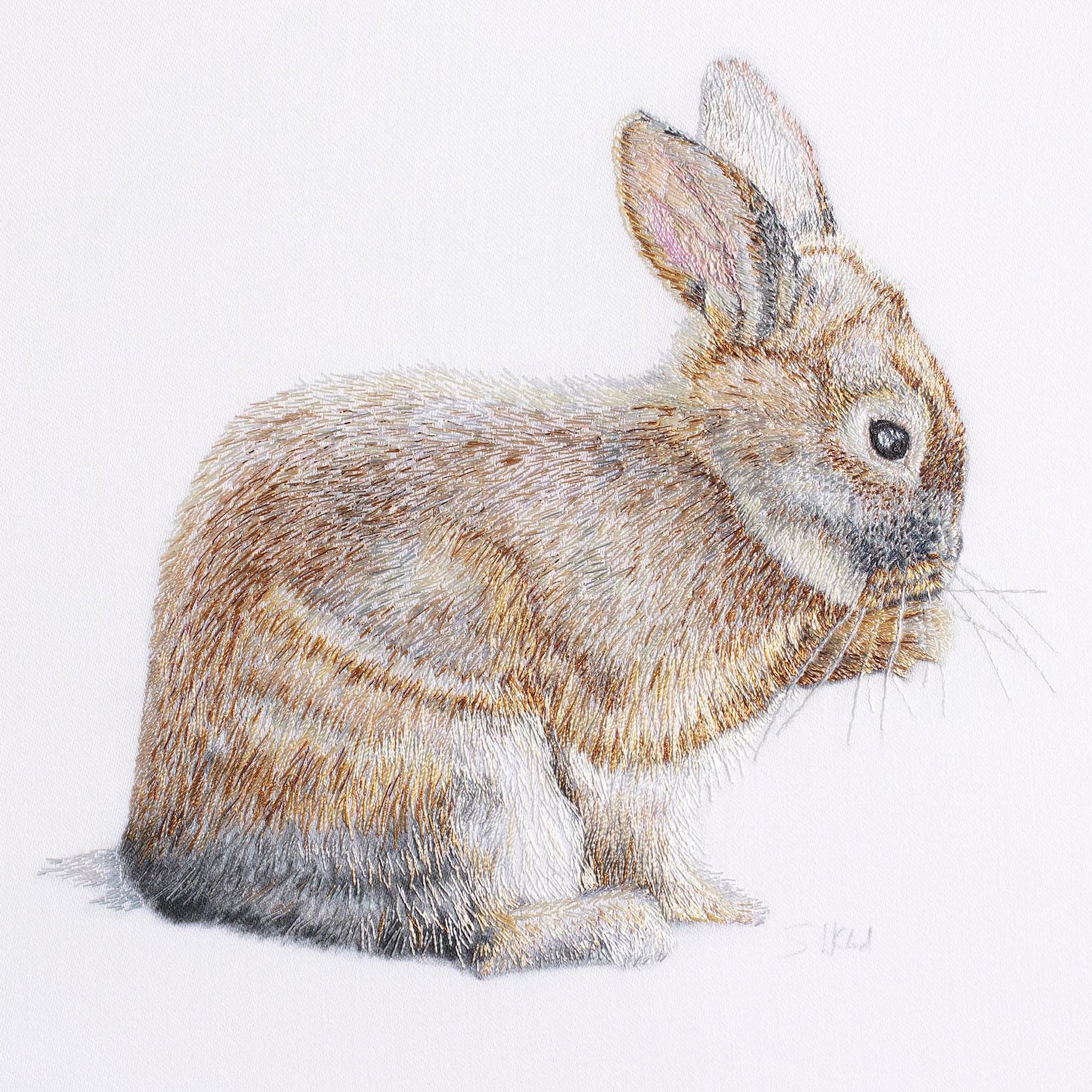 Bunny rabbit hand embroidered artwork.