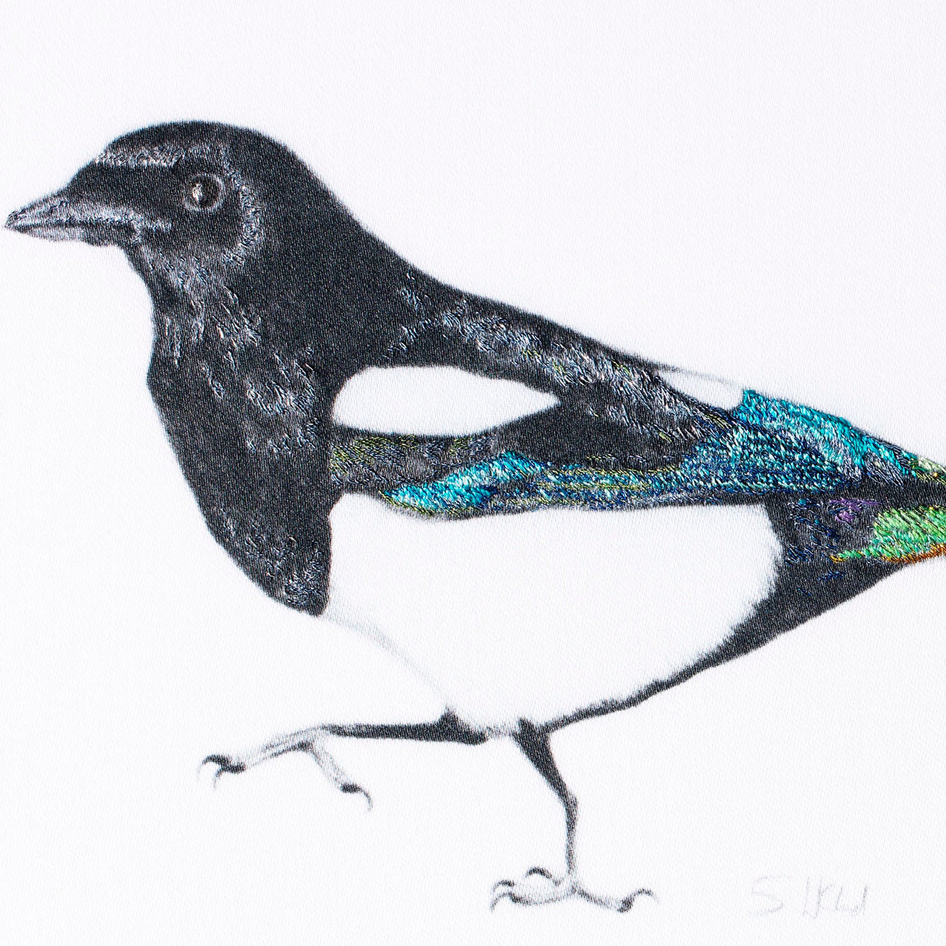 Magpie hand embroidered wall art close up.
