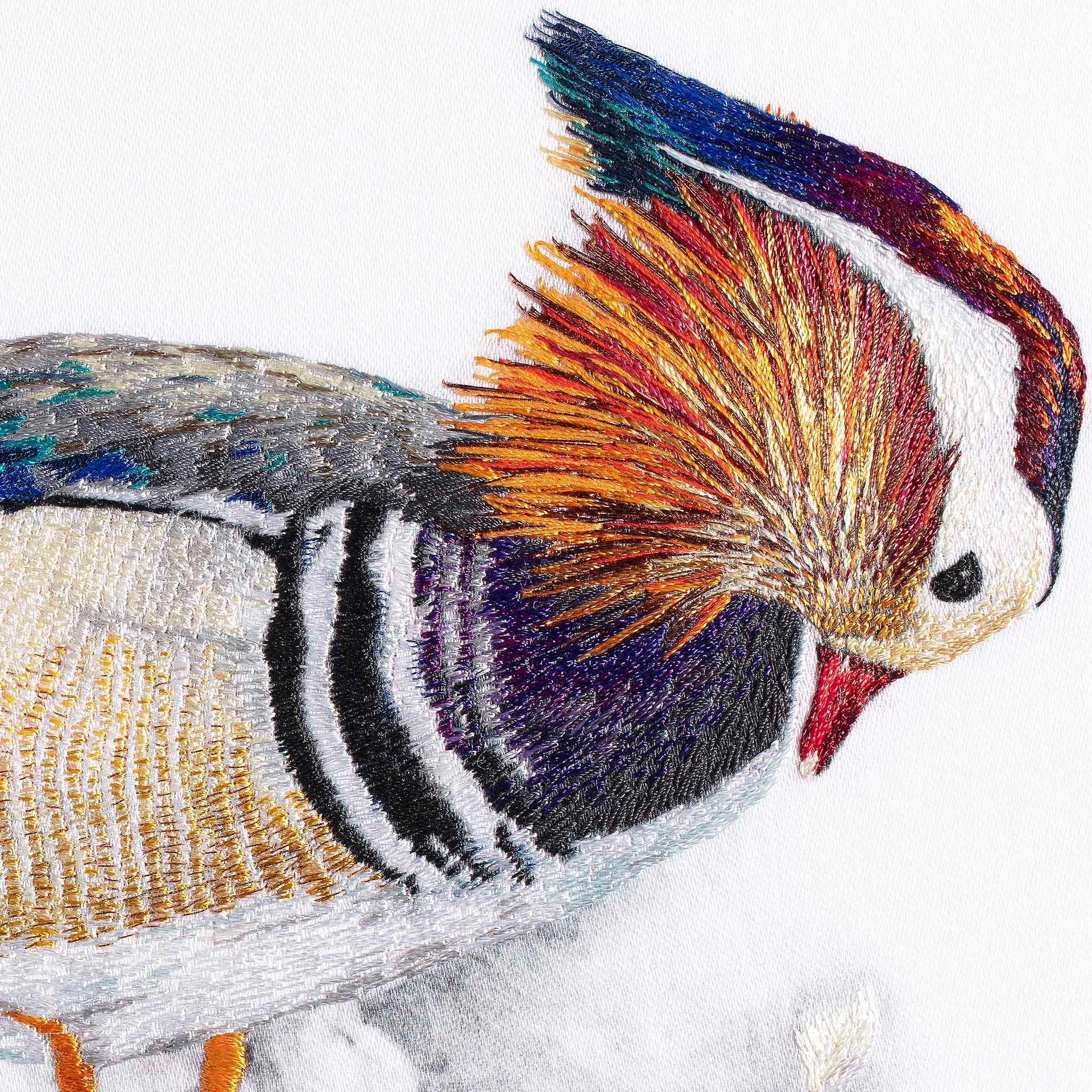 Mandarin duck with fish hand embroidered wall art close up.