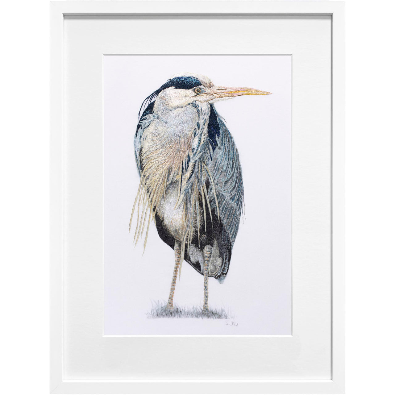 Richmond Riverside Heron by Susannah Weiland, in a white frame. An original hand embroidery of a grey heron standing upright on long legs, its body hunched and plumes trailing. Stitched in steely blues, soft greys and warm golden tones on cotton-satin fabric. From the Royal Park Life collection.