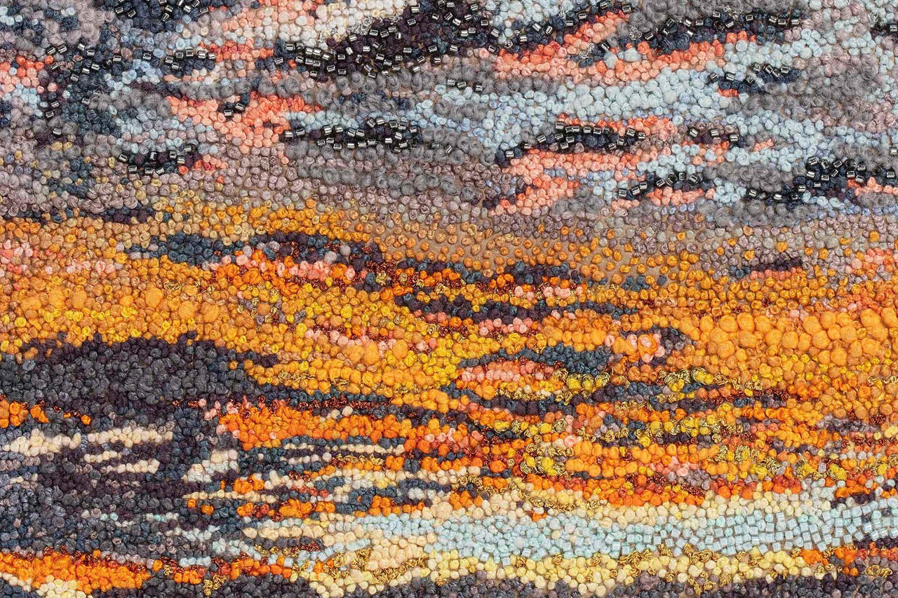 June Sky by Susannah Weiland, an original hand embroidery of an abstract sunset rendered in dense French knots in layers of fiery orange, coral, gold, teal and deep purple. Selected for Resonance, Sussex Contemporary, Fabrica Gallery, Brighton, April 2026.
