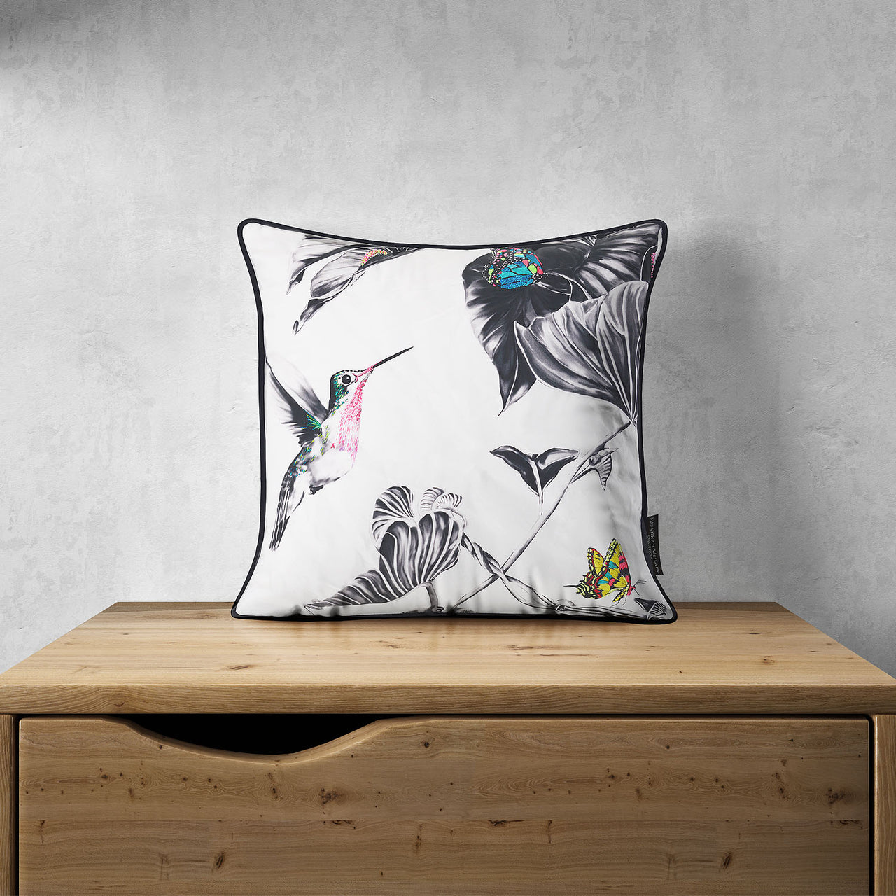 Hummingbird cushion on chest of drawers