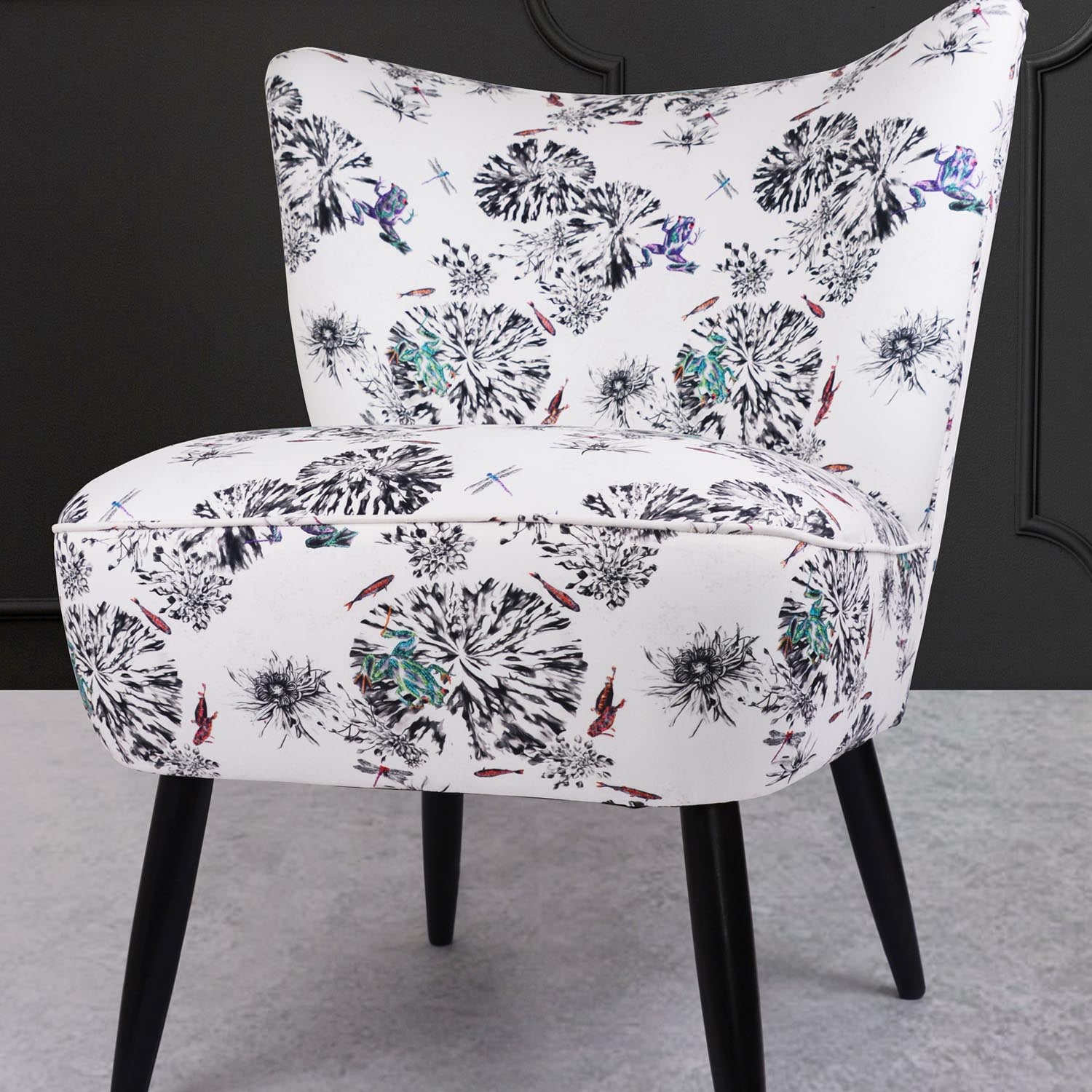 Cocktail chair upholstered in multi frogs fabric