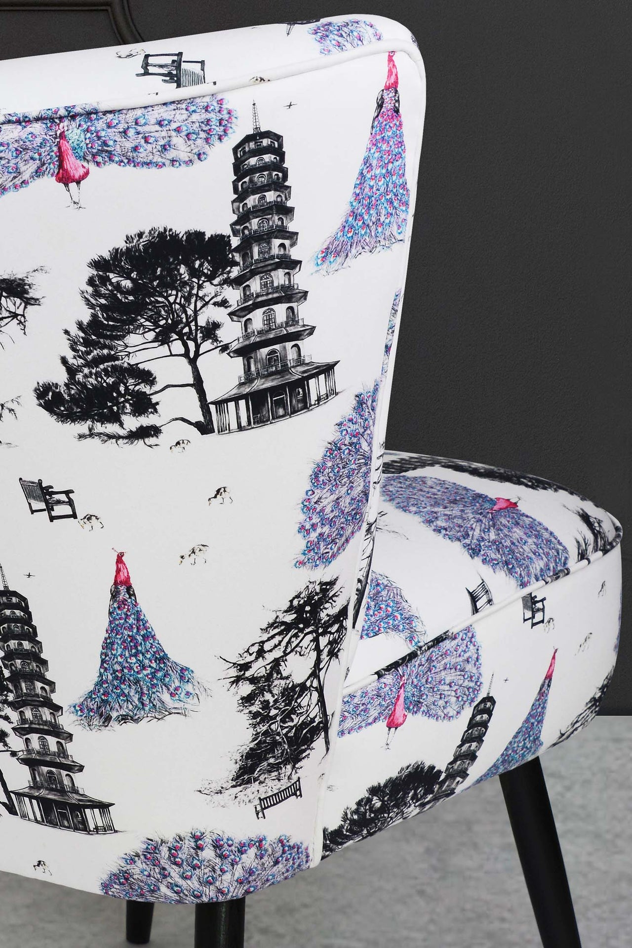 Cocktail chair upholstered in pink kew peacocks fabric.