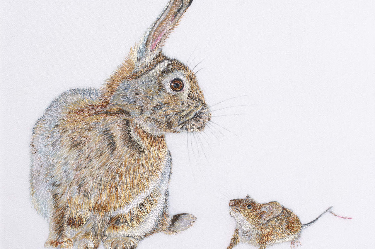Greenwich Rabbit & Mouse by Susannah Weiland, an original hand embroidery depicting a rabbit and mouse in close company, stitched in warm tawny and grey threads on pale fabric. A print of this artwork has been selected for This Love, Burgh House, London, June 2026.