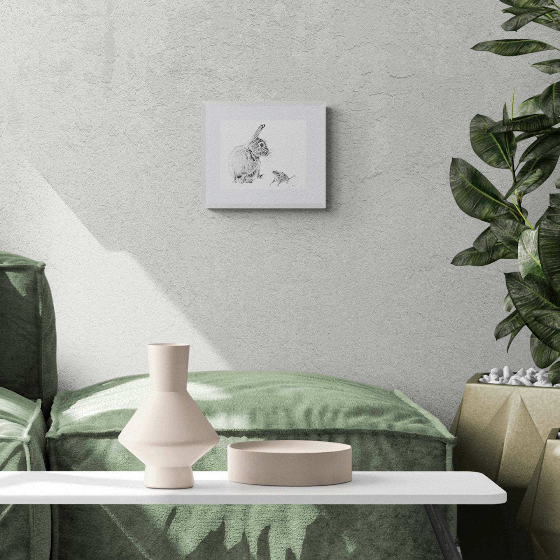 Rabbit and mouse drawing in white frame on wall