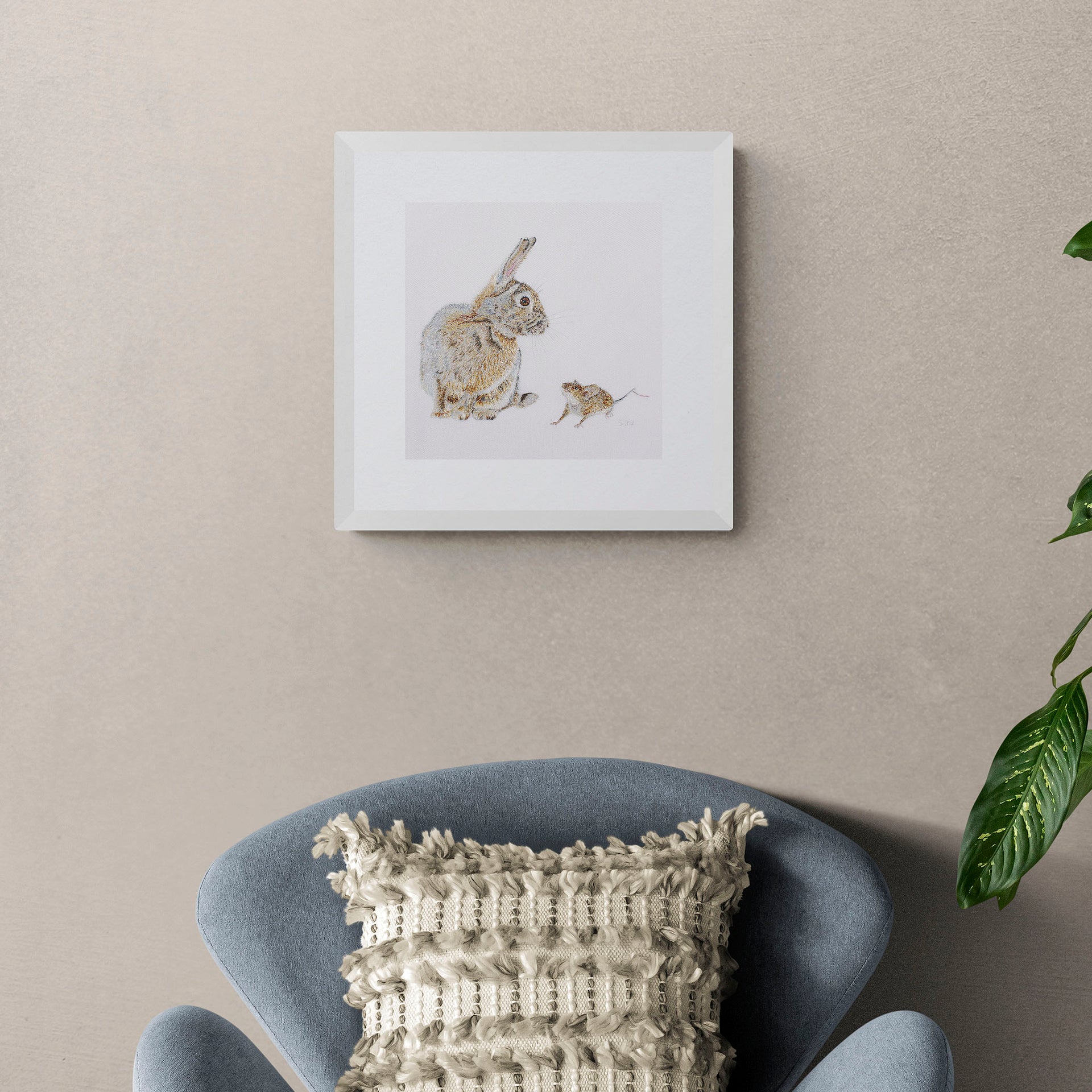 Hand embroidered rabbit and mouse artwork on the wall
