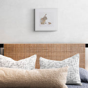 Hand embroidered rabbit and mouse artwork in white frame on wall