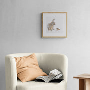 Hand embroidered rabbit and mouse artwork in wooden frame on wall