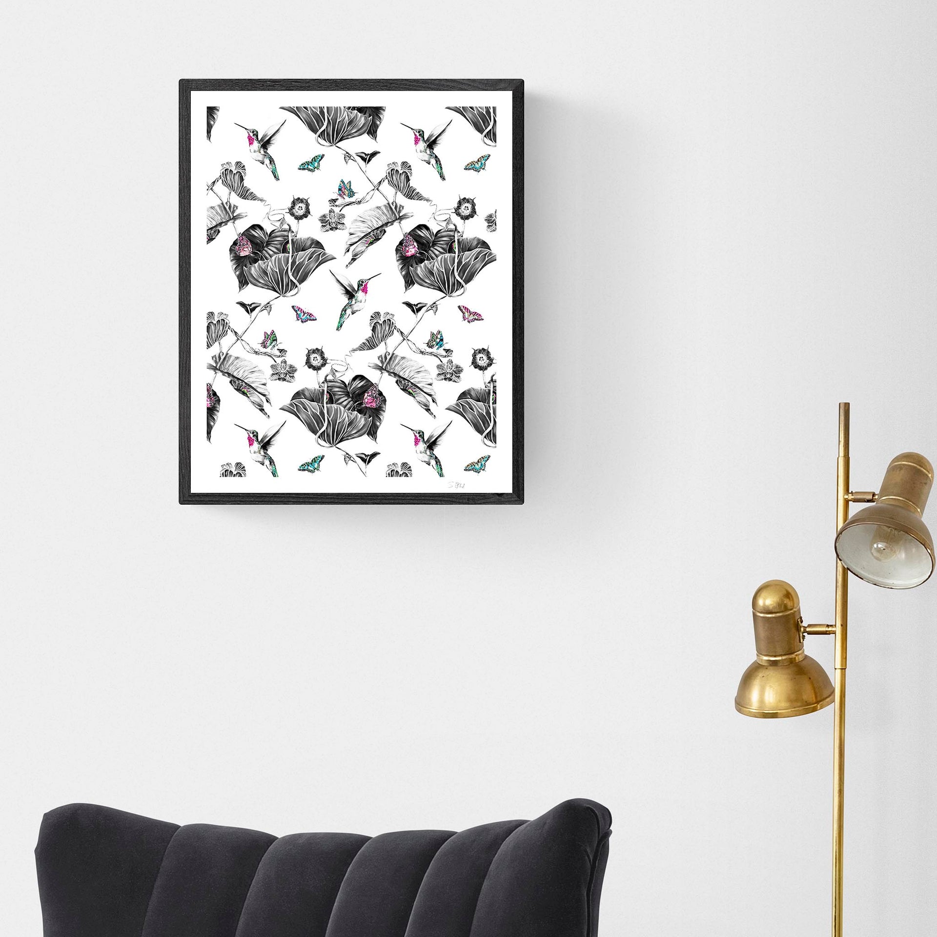 Pink hummingbird limited edition print in black frame on wall