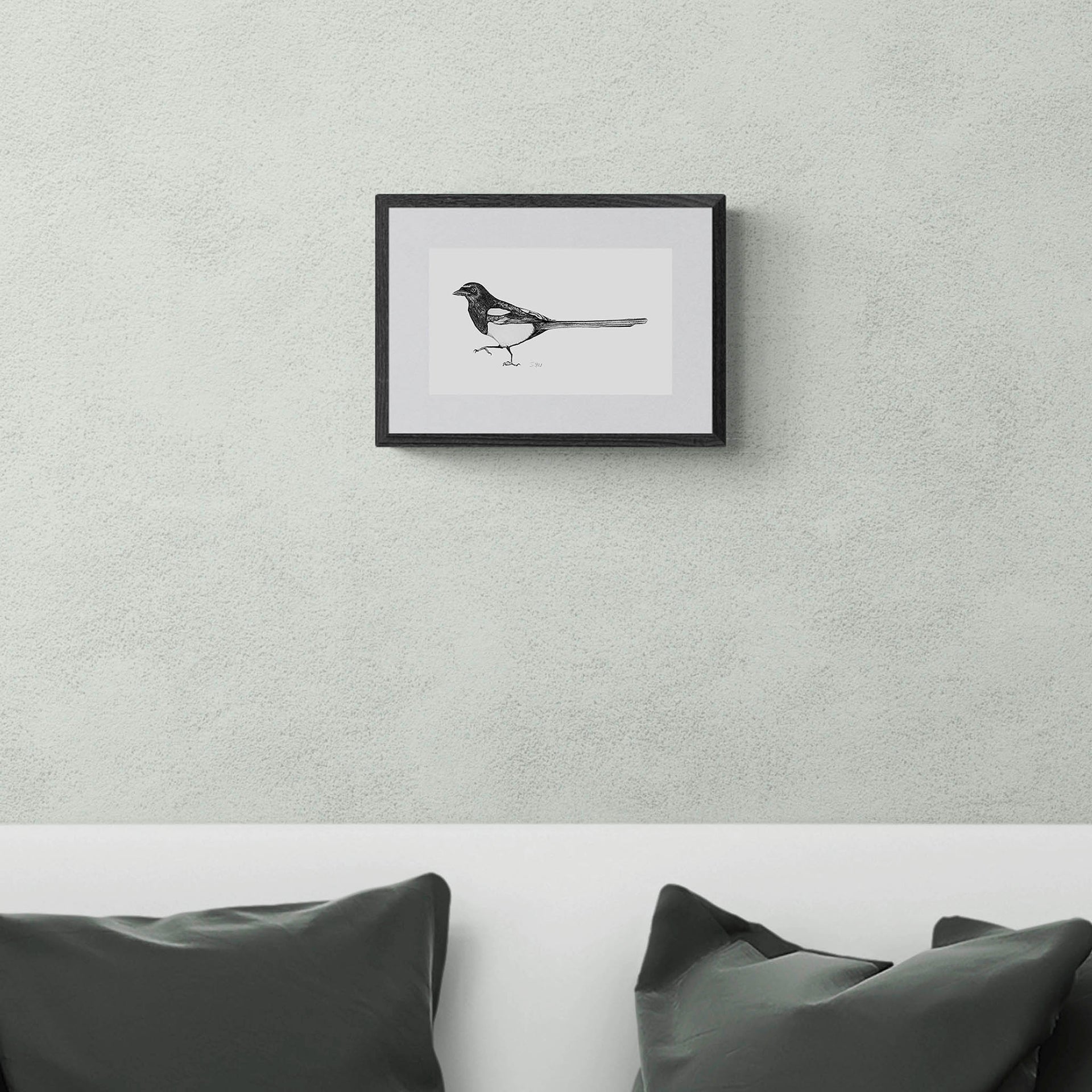 Magpie drawing limited edition print in black frame on the wall