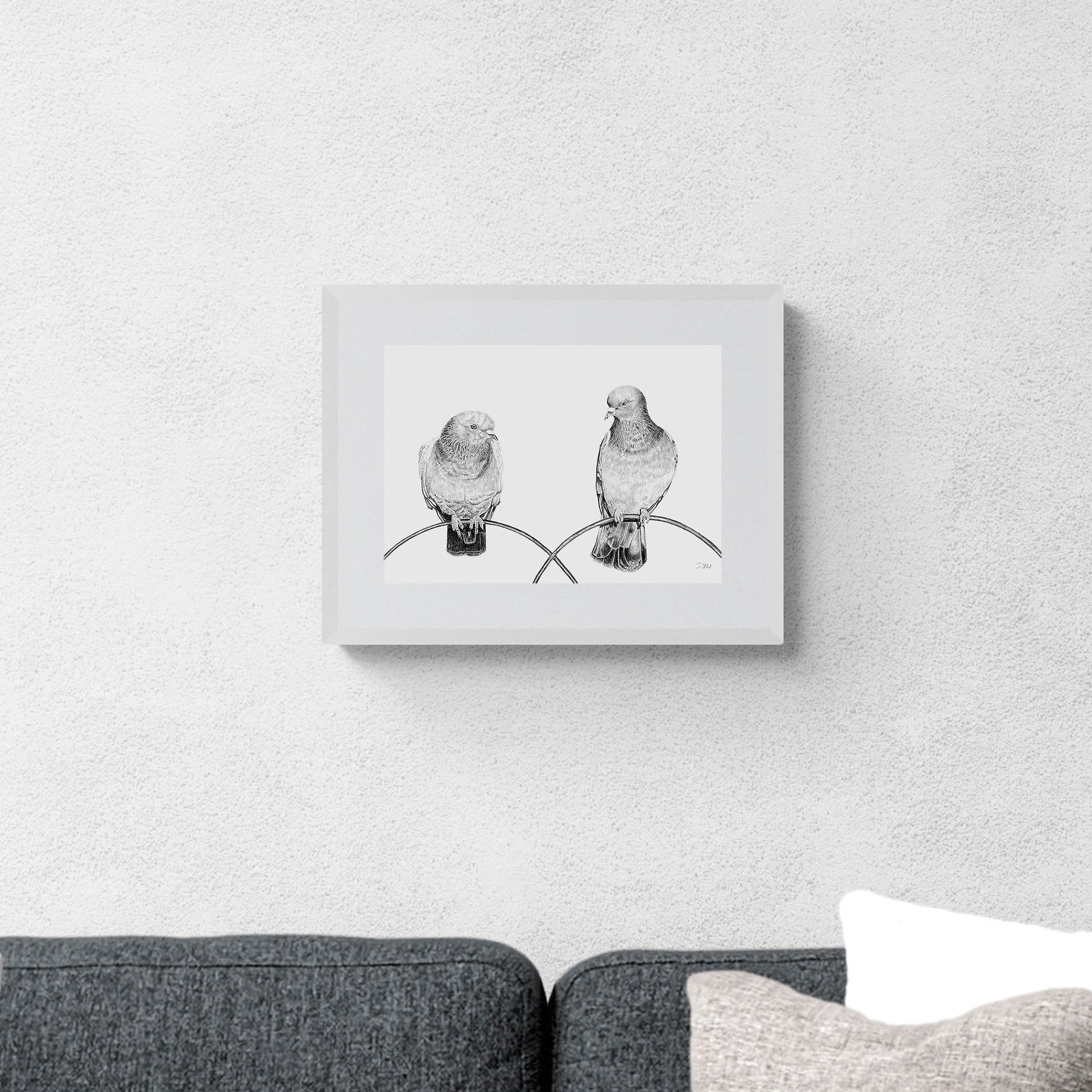 Pigeons pencil drawing print in white frame on the wall