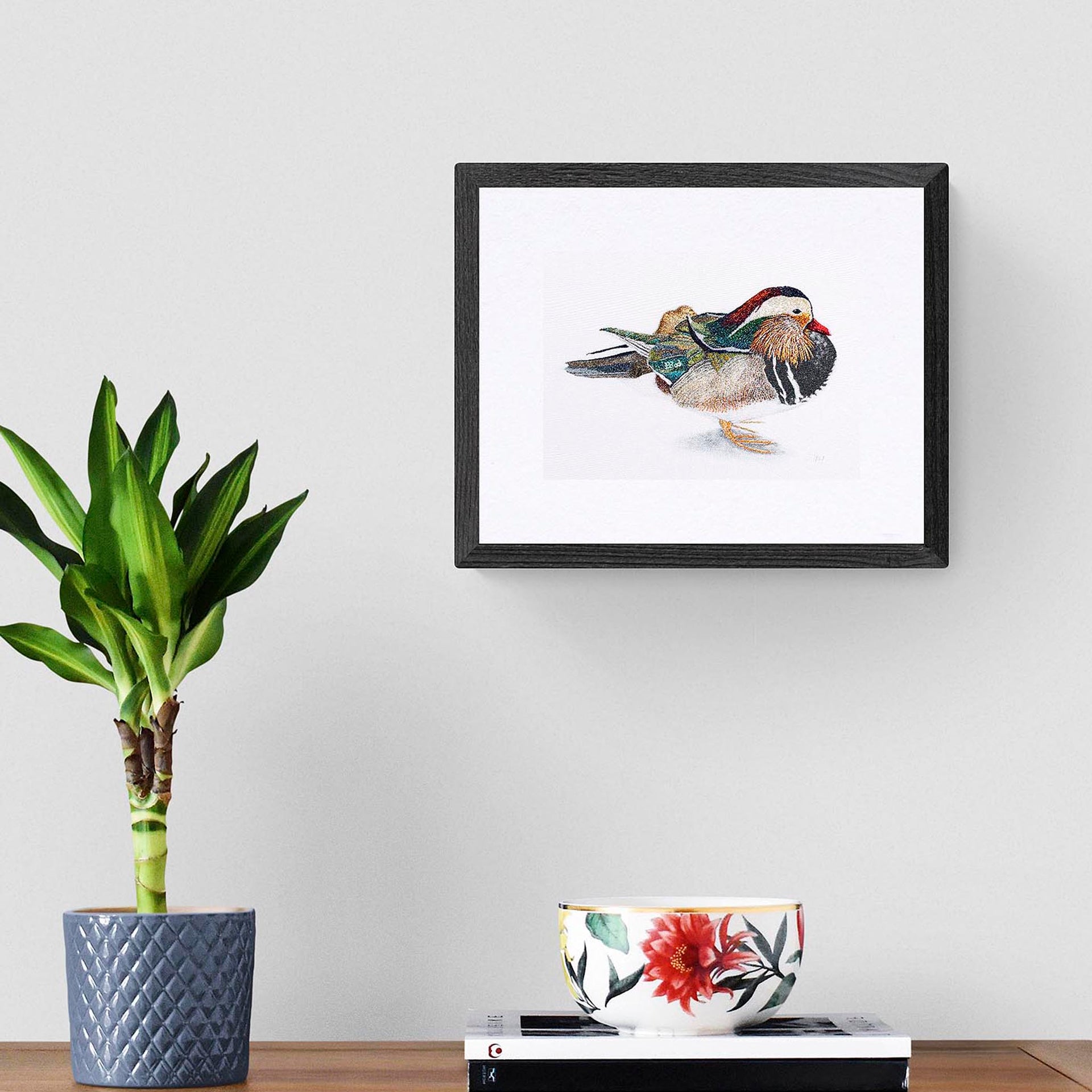 Mandarin duck hand embroidered limited edition print in black frame on the wall