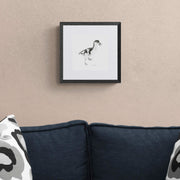 Gosling pencil drawing print in black frame on the wall
