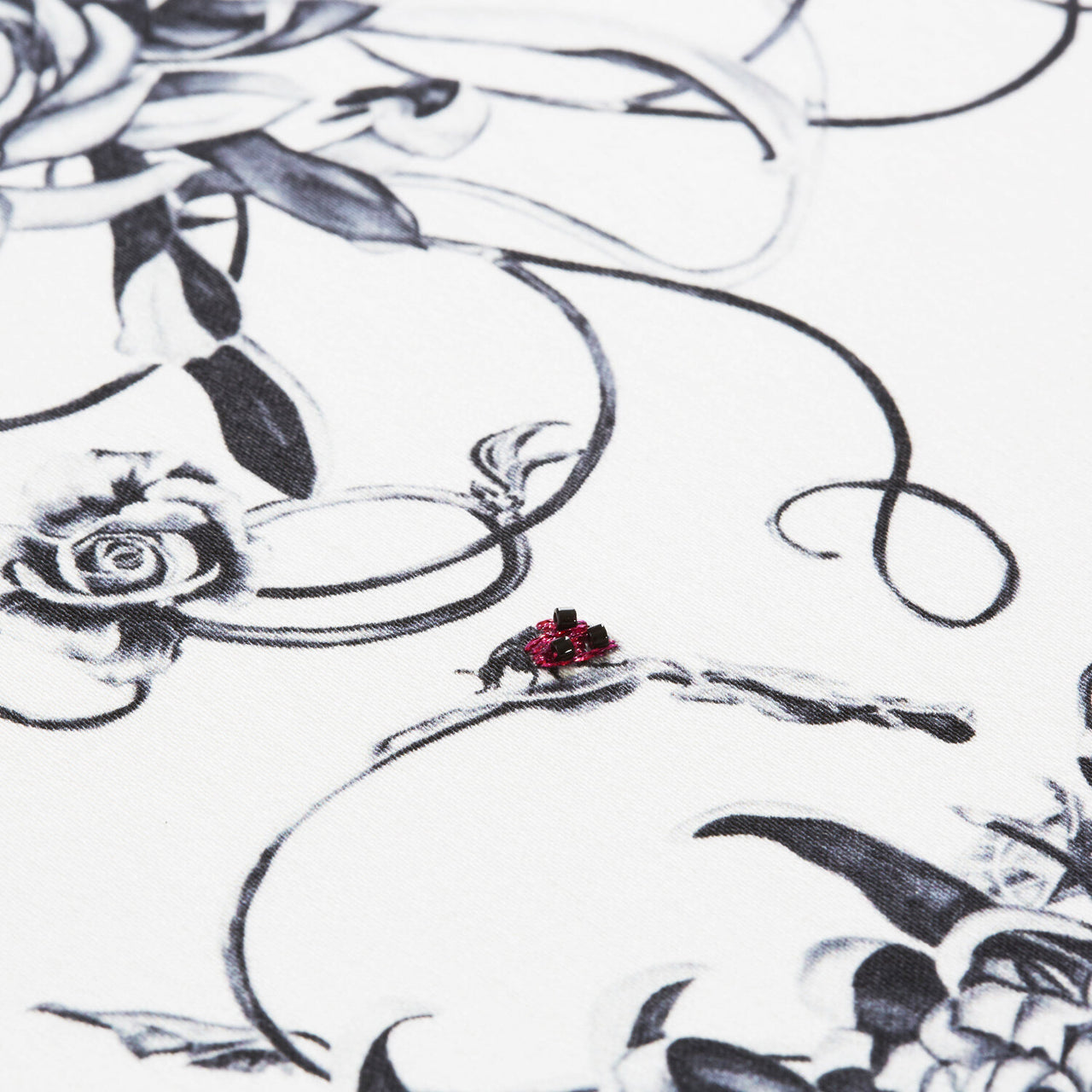 Mini cushion with hand embroidered ladybirds close up