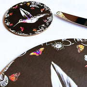 Black hummingbird coaster on table