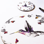 White hummingbird coaster on table