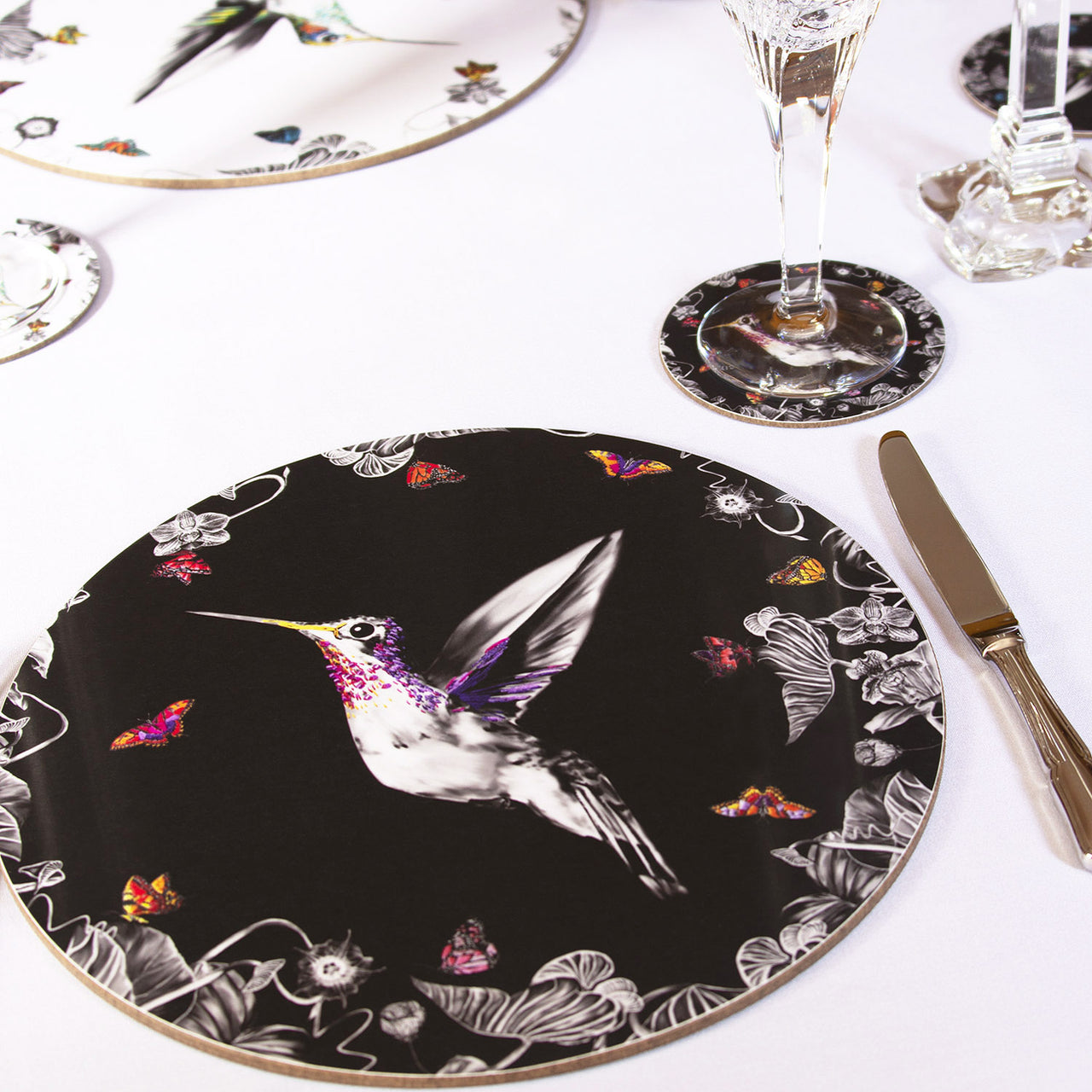 Black hummingbird placemat on table