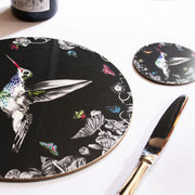 Black hummingbird coaster on table