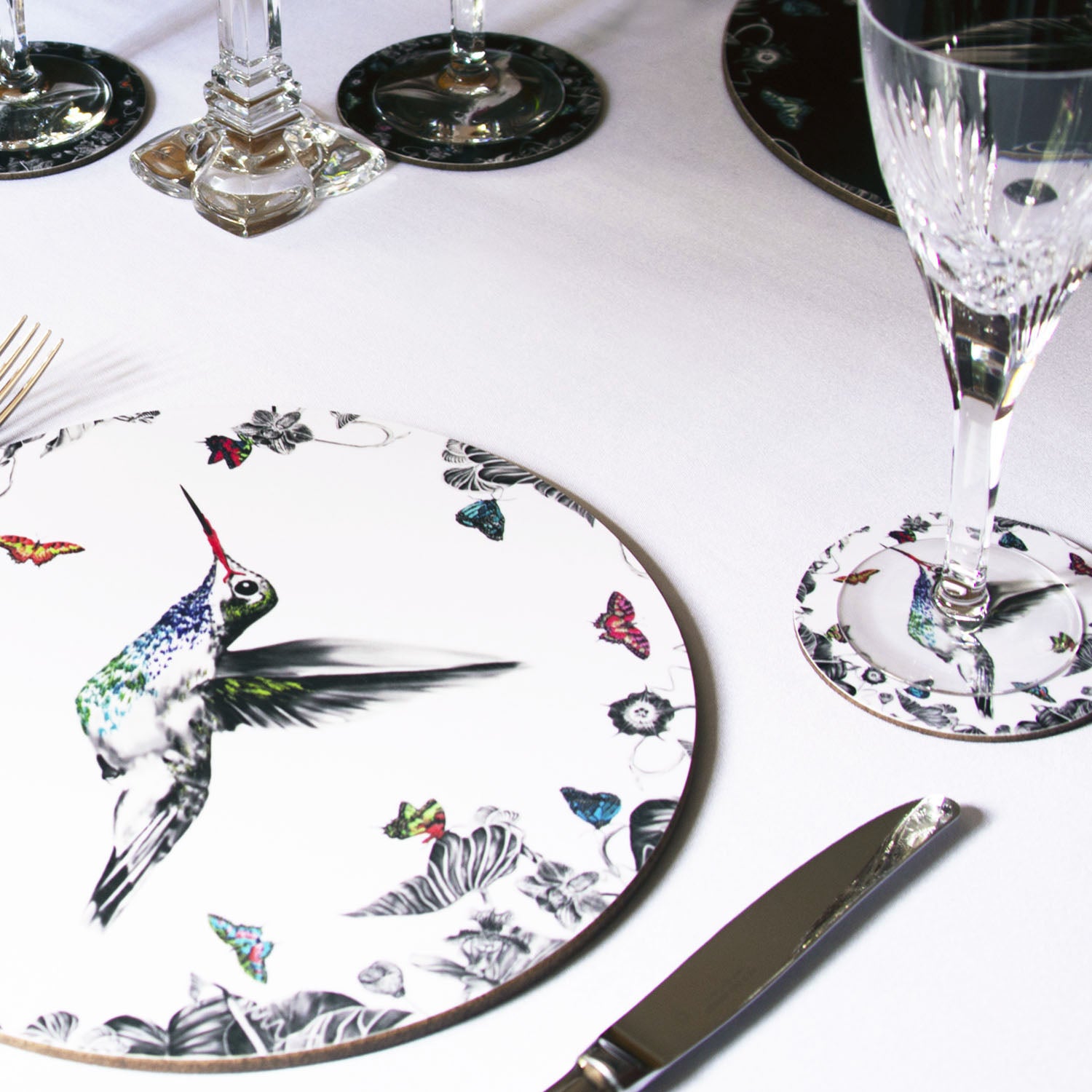 White hummingbird placemat on table setting