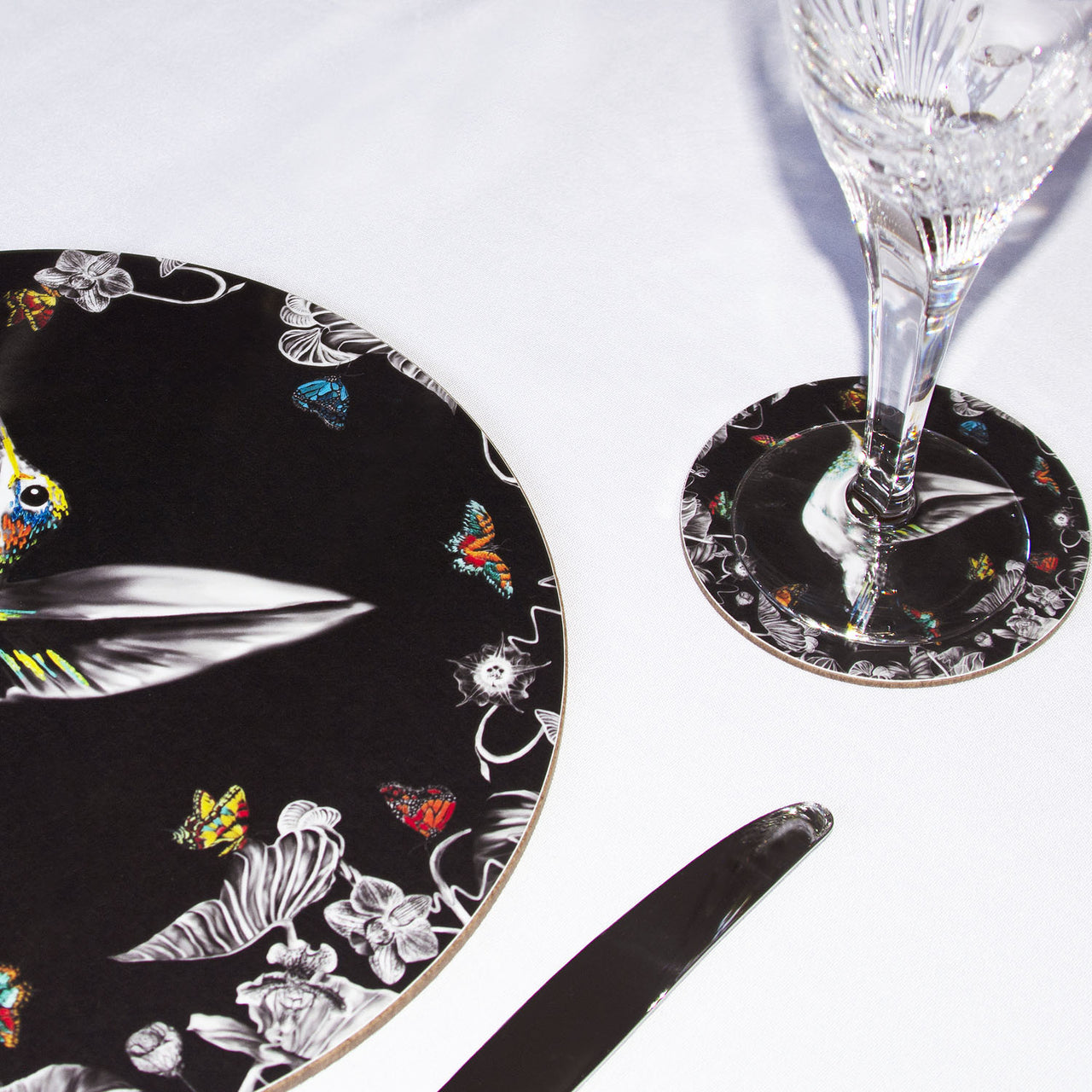 Black hummingbird coaster on table