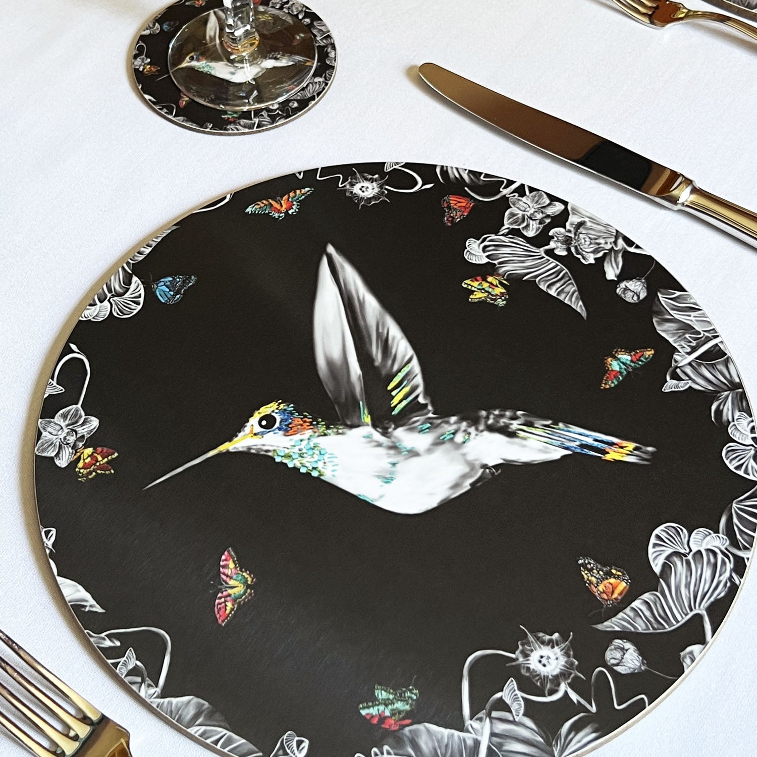 Black hummingbird placemat on table