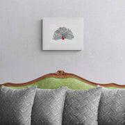 Peacock hand embroidered limited edition print in white frame on the wall